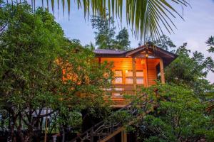 a cabin in the middle of some trees at Woodgreens Heritage Resorts in Kannur