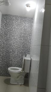 a bathroom with a white toilet in a room at Hotel Ferrari in Sao Paulo