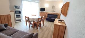 a living room with a couch and a table at Cauterets centre - Résidence Le marcadau 1 in Cauterets