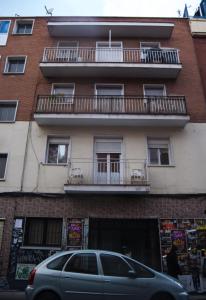 un edificio con un'auto parcheggiata di fronte di aparment puerto Alto a Madrid