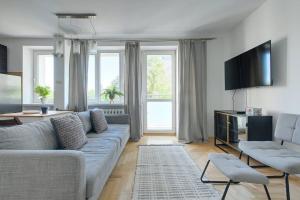 a living room with a couch and a tv at Palace View near Złote Tarasy Apartment in City Center in Warsaw