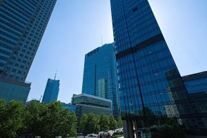 a group of tall buildings in a city at Palace View near Złote Tarasy Apartment in City Center in Warsaw