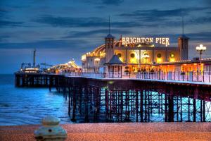 a pier with a brighton pier at night at Brighton City Flat Perfect for long stays in Brighton & Hove
