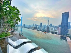 a infinity pool with a view of a city at Axon Residence Bukit Bintang By TR Suites in Kuala Lumpur