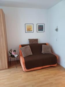 an orange couch sitting in a living room at Business Apartment in Berlin