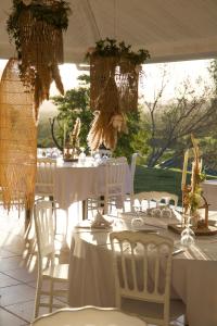 einen Tisch mit weißen Tischen und Stühlen in einem Zelt in der Unterkunft Rivland Resort in Païta