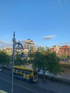 a yellow bus parked on the side of a street at The Ground Snug Private Room in Dublin