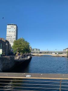 a view of a river with buildings in the background at The Ground Snug Private Room in Dublin