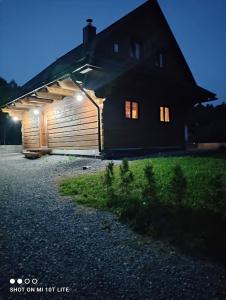 a wooden building with lights on the side of it at Chata Starý Mlyn in Habovka