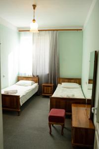 a bedroom with two beds and a window at Ners Guest House in Gyumri
