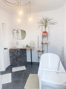 a bathroom with a tub and a sink and a mirror at CASA RURAL GA7COLORES only adult in Montaña Blanca