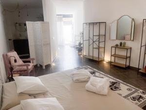a room with a bed with towels on it at CASA RURAL GA7COLORES only adult in Montaña Blanca
