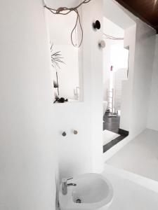 a white bathroom with a sink and a mirror at CASA RURAL GA7COLORES only adult in Montaña Blanca
