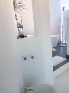 a white bathroom with a mirror and a sink at CASA RURAL GA7COLORES only adult in Montaña Blanca