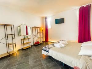 a bedroom with two beds and a window with red curtains at CASA RURAL GA7COLORES only adult in Montaña Blanca