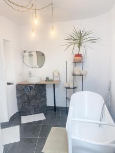 a bathroom with a sink and a mirror and a tub at CASA RURAL GA7COLORES only adult in Montaña Blanca