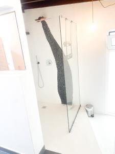 a shower stall with a persons leg sticking out of it at CASA RURAL GA7COLORES only adult in Montaña Blanca