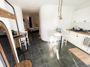 a kitchen and dining room with a table and chairs at CASA RURAL GA7COLORES only adult in Montaña Blanca