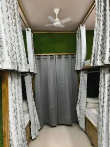 a bedroom with two bunk beds and curtains at Shree Madhvam AC Dormitory in Varanasi