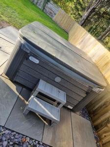 a picnic table sitting on top of a table at 3 Bed Detached House & Hot Tub in Wrexham