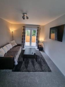 a living room with a couch and a coffee table at 3 Bed Detached House & Hot Tub in Wrexham