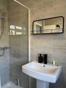 bagno con lavandino, doccia e specchio di Modern and Comfy House, Sky sports, PS3 a Gateshead