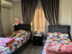 a bedroom with two beds and a teddy bear at المقطم,شارع 13,قطعه 331 in Cairo