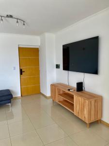 a living room with a flat screen tv on a wall at Departamentos Leloir in Neuquén