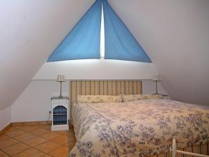 a bedroom with a large bed with a large window at Semi-detached house, Zingst in Zingst