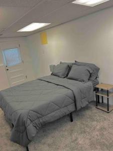 a bedroom with a large bed and a table at 5BR House Close to Stadium/Downtown in Ann Arbor