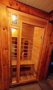 a wooden sauna with a wooden bench in a room at Chata Koza in Bublava