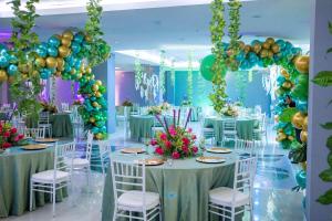 a banquet hall with tables and chairs and balloons at Hotel City Plaza & Suites in David
