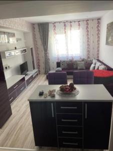 uma cozinha e sala de estar com um sofá e uma mesa em MARCY APARTAMENT em Bucareste