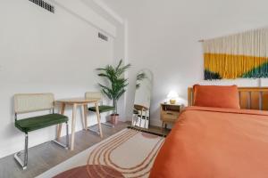 a bedroom with a bed and a table and a chair at Tropics Hotel Miami Beach in Miami Beach