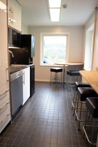 a kitchen with a table and chairs and a window at Landvetter Hotell in Härryda