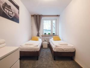 two beds in a small room with a window at 71, ***3beds: Deluxe Warm Suite in Warsaw Manhattan*** in Warsaw