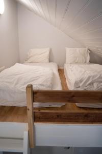 two beds in a small room with white walls at Landvetter Hotell in Härryda