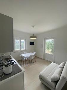 a kitchen with a couch and a table in a room at Villa Vittoria in Peschici