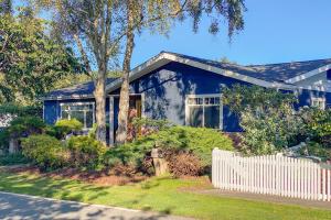 a blue house with a white fence in front of it at Trinidad Village Retreat in Trinidad