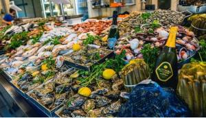 a large display of seafood and bottles of champagne at B & B CANTARANO in Porto Garibaldi