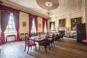 a dining room with a long table and chairs at Lytham Hall Gate House in Lytham St Annes