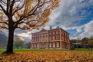 a large brick building with a tree in the foreground at Lytham Hall Gate House in Lytham St Annes
