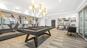 a living room with a pool table and a bill at Global Luxury Suites Irvine in Irvine +37 photos