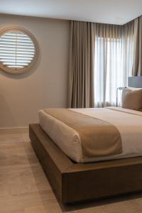 1 dormitorio con 1 cama grande y ventana en Nassau Suite South Beach, an All Suite Hotel, en Miami Beach