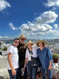 a group of people wearing hats standing on a roof at House with sea view in Kasbah in Tangier