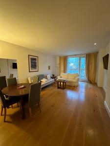 a living room with a table and a couch at Canary Wharf 1 bed apartment in London