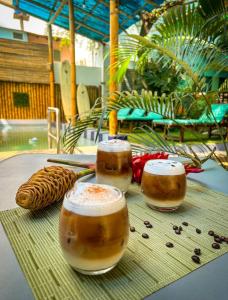 a table with two cups of coffee and some food at Rincón d'Olón Boutique Hotel in Olón
