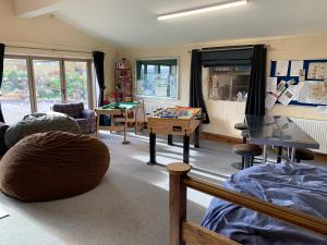 a living room with a table and a tableasteryasteryasteryasteryasteryasteryastery at Cuthbert Hill Farm in Preston