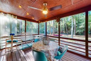 a screened in porch with a table and chairs at The Red House at the Beach in Ocean Pines