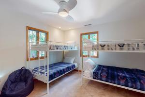 two bunk beds in a room with a ceiling at The Red House at the Beach in Ocean Pines
